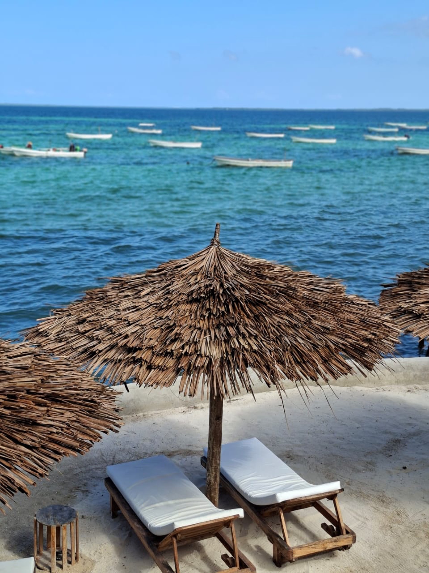 Private beach with thatched umbrellas at Moya Beach Hotel
