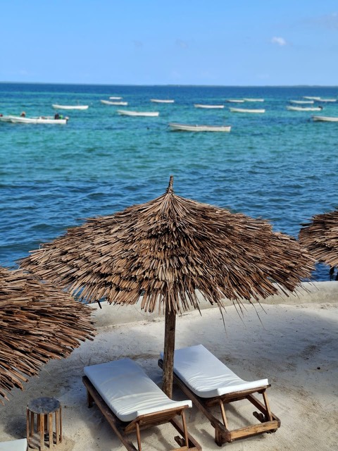 Beach umbrella with fishing boats